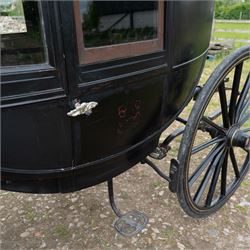 Town Coach by John Marstons Birmingham - Ex Film

A black painted five glass Town Coach by John Marston's Carriage Works Ltd, Birmingham, with enclosed glazed passenger compartment, curved front glass, external coachman's box seat and pole for driving with a pair of horses. The carriage has a timber coach body with buttoned black leather interior, blue upholstered seat cushions, plated exterior door handle, maker plates to the body and step, and John Marston marked hub caps. Mounted on black painted wooden spoked wheels with rubber tyres, leaf spring suspension, underbody turntable steering and iron fittings throughout.
Featured on the film set of 'Victoria' with Jenna Coleman

Features

• Black painted enclosed coach body
• Glazed passenger compartment with five windows
• Curved front glass
• Buttoned black leather interior
• Blue upholstered seat cushions
• External coachman's box seat
• Timber coach body
• Wooden spoked wheels
• Rubber tyres
• Leaf spring suspension
• Underbody turntable steering
• Pole for pair of horses
• Iron foot steps
• Plated exterior door handle
• Maker plates for John Marston's Carriage Works Ltd, Birmingham
• John Marston marked hub caps
• Featured on the film set of Victoria with Jenna Coleman

Dimensions:
Overall length: 390 cm
Width: 190 cm
Height: 214 cm

Wheel Diameters:
Front wheels: 104 cm
Rear wheels: 134 cm

Seating:
Coachman's box: 2
Passenger compartment: 4