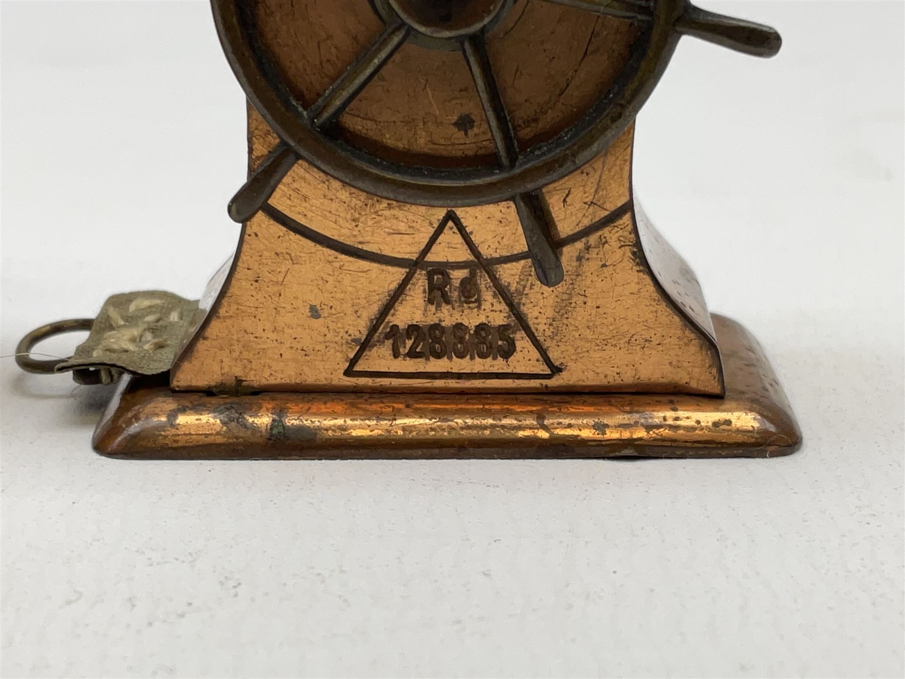 Copper tape measure in the form of a ship`s wheel, marked 'Rd. 128885' to the front, and a celluloid tape measure in the form of a galleon, wheel H4cm