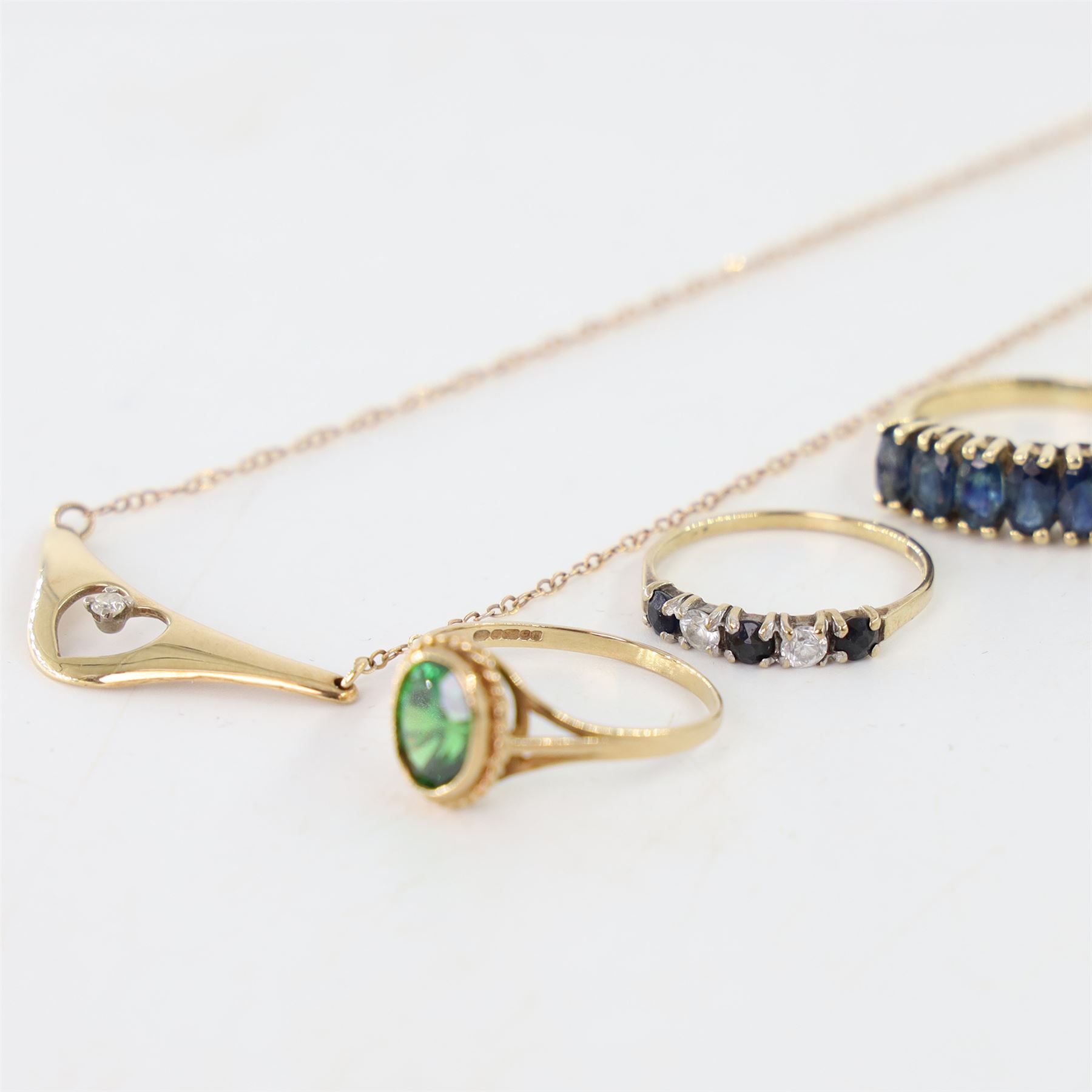 9ct gold jewellery including diamond pendant necklace, six stone sapphire ring, green stone set ring and a sapphire and cubic zirconia ring