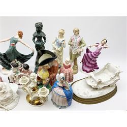 A group of assorted figures, to include two Art Deco style examples, and three small wall masks, a pair of bisque figures modelled as children seated in barrels, a further pair of bisque figures modelled as a courting couple, a Continental figure group, Toby jug, etc. 