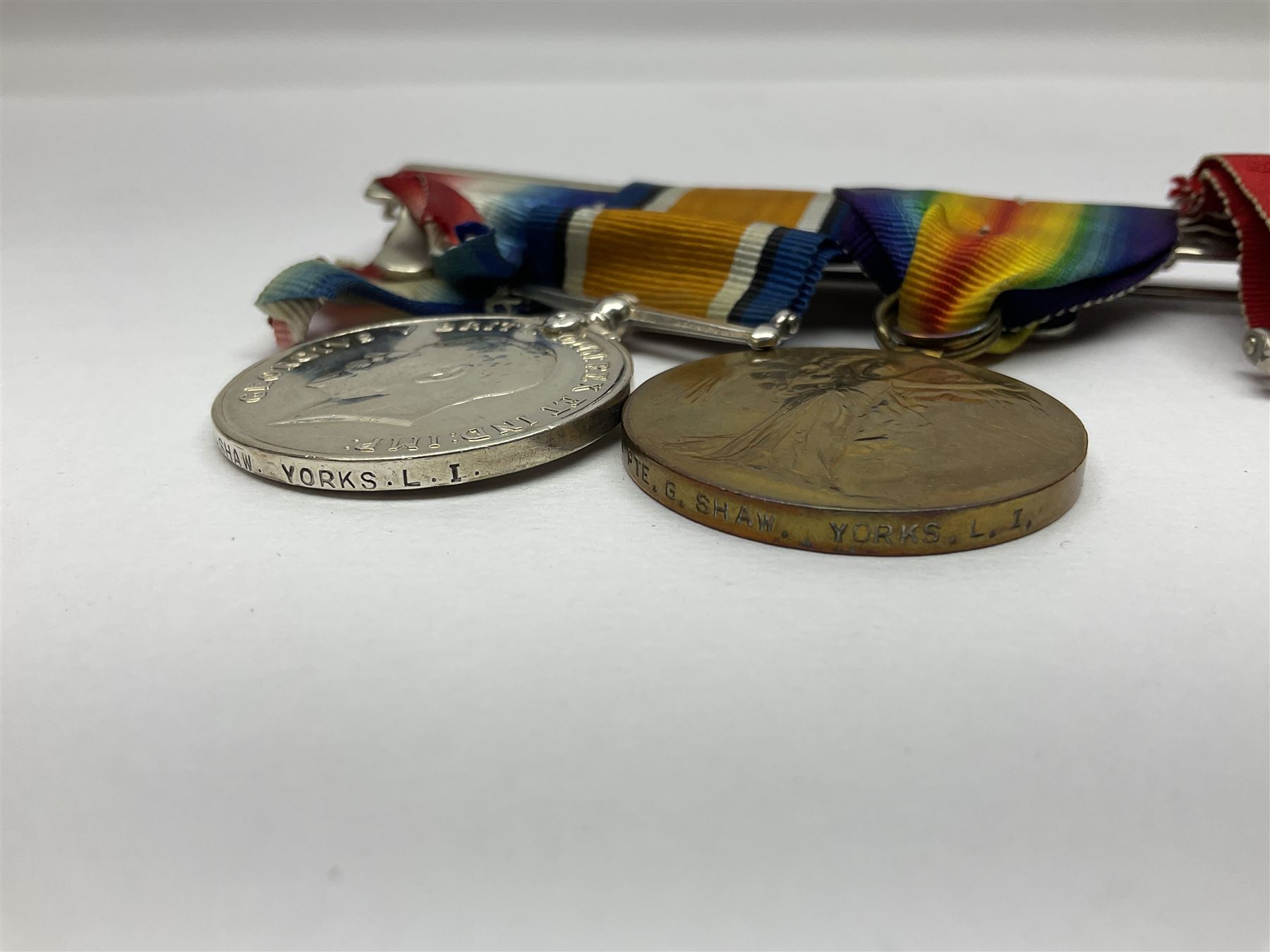 WW1 group of three medals comprising British War Medal, Victory Medal and 1914 Star awarded to 8328 Pte. G. Shaw Yorks: L.I.; on hanging bar with WW2 1939-1945 War Medal and WW1 ribbon bar with rosette to 1914 Star ; all with ribbons; and WW2 1939-1945 War Medal with ribbon