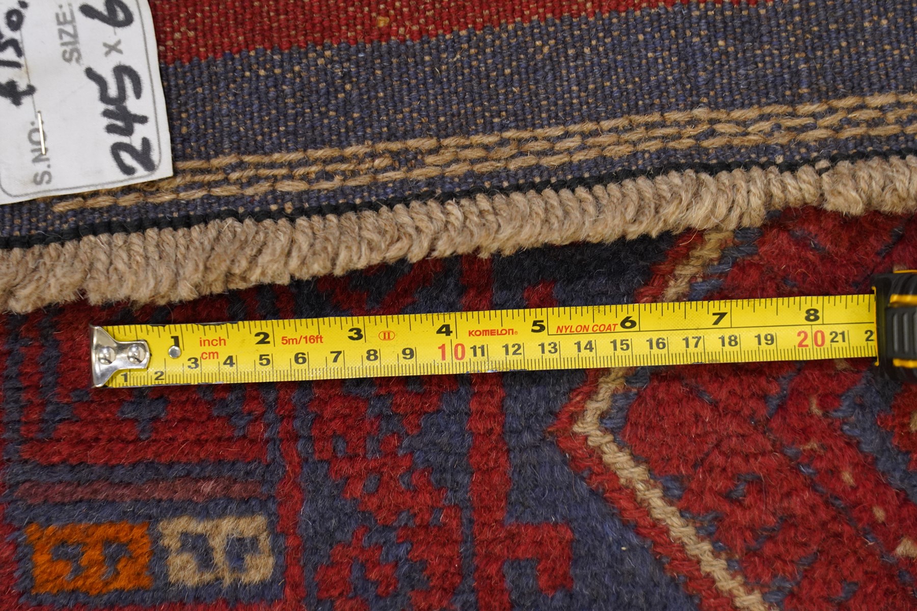 Near pair of Afghan Meshwani runner rugs, each with four red lozenge medallions on a blue ground interspersed with hooked geometric motifs, enclosed by patterned red borders, striped kilim end panels (2)