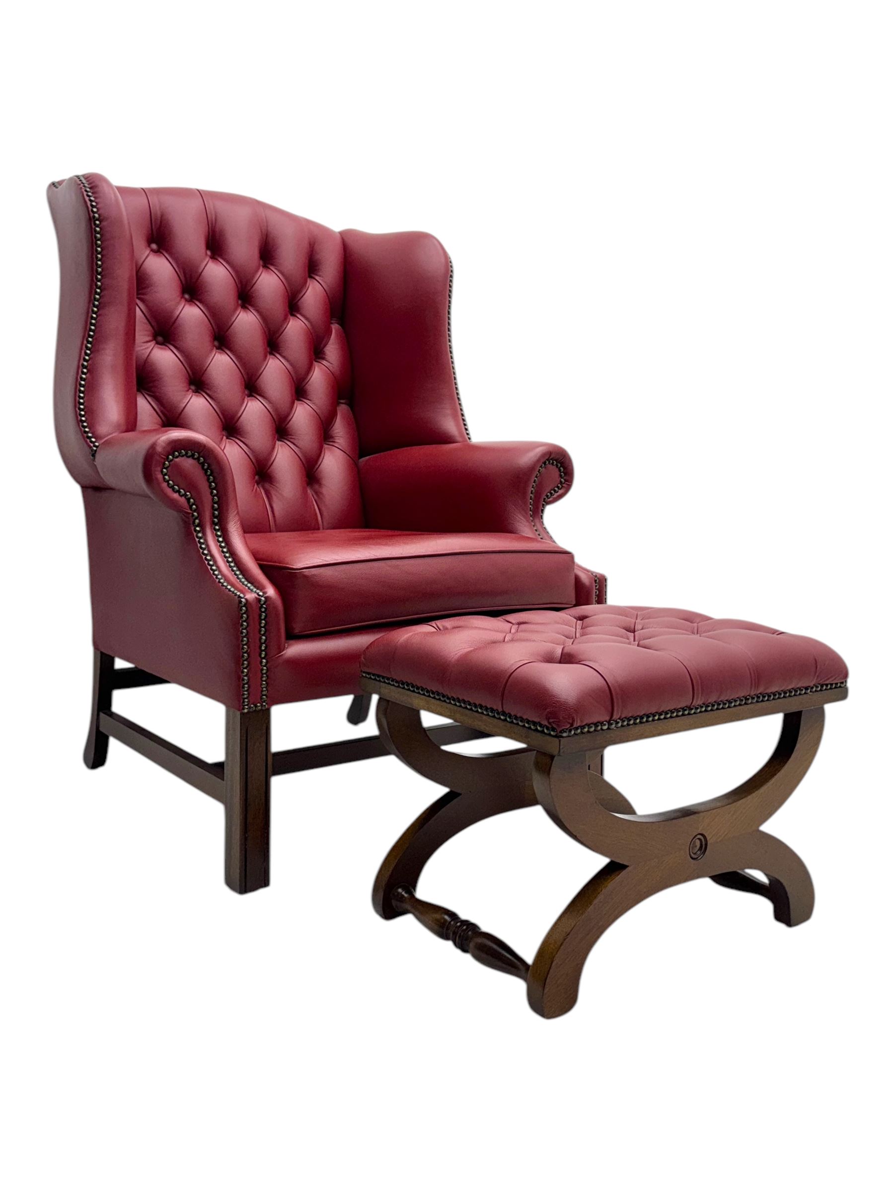 Kingsgate - contemporary 'Suffolk' wingback armchair and matching stool, upholstered in red leather with deep button tufting and brass stud trim, raised on square section supports 