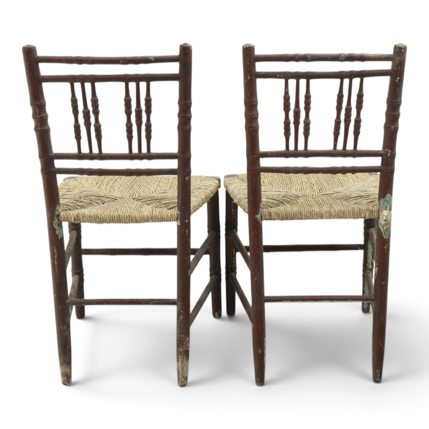 Pair of 19th century lacquered faux bamboo rush seated side chairs chairs, original blue paint under later ox-blood lacquer finish