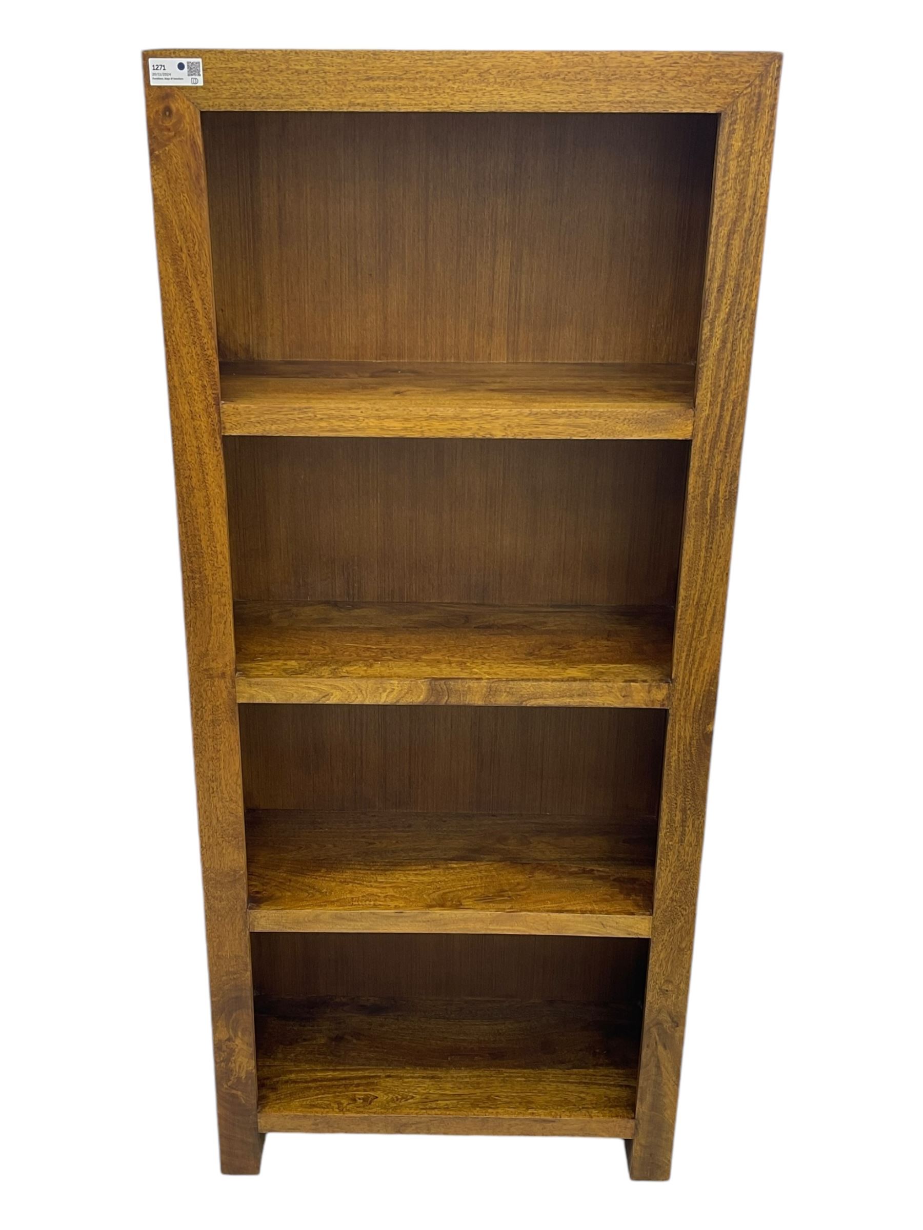 Contemporary Dakota mango wood open bookcase, rectangular form with four fixed open shelves, raised on stile supports
