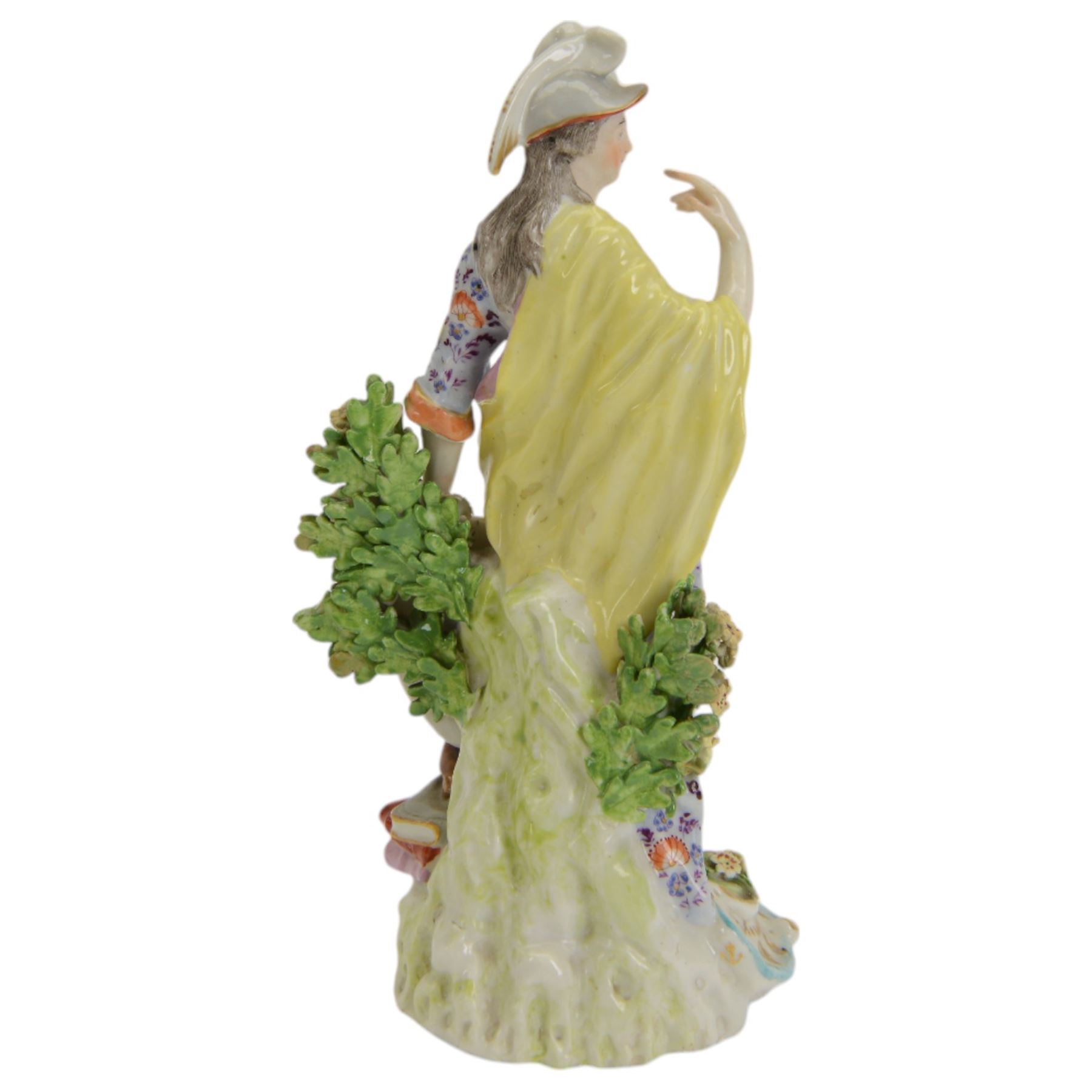 18th century Derby porcelain figure, circa 1775, modelled as Minerva, standing with mask shield, books and owl, against flowering bocage, upon a scroll base encrusted with flowers, H23cm
