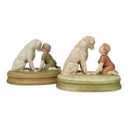 Two Royal Dux figures, each modelled as a toddler and dog, upon oval base, one titled 'Can't you talk?', model no 2369, each with applied and impressed marks beneath, largest example H19cm