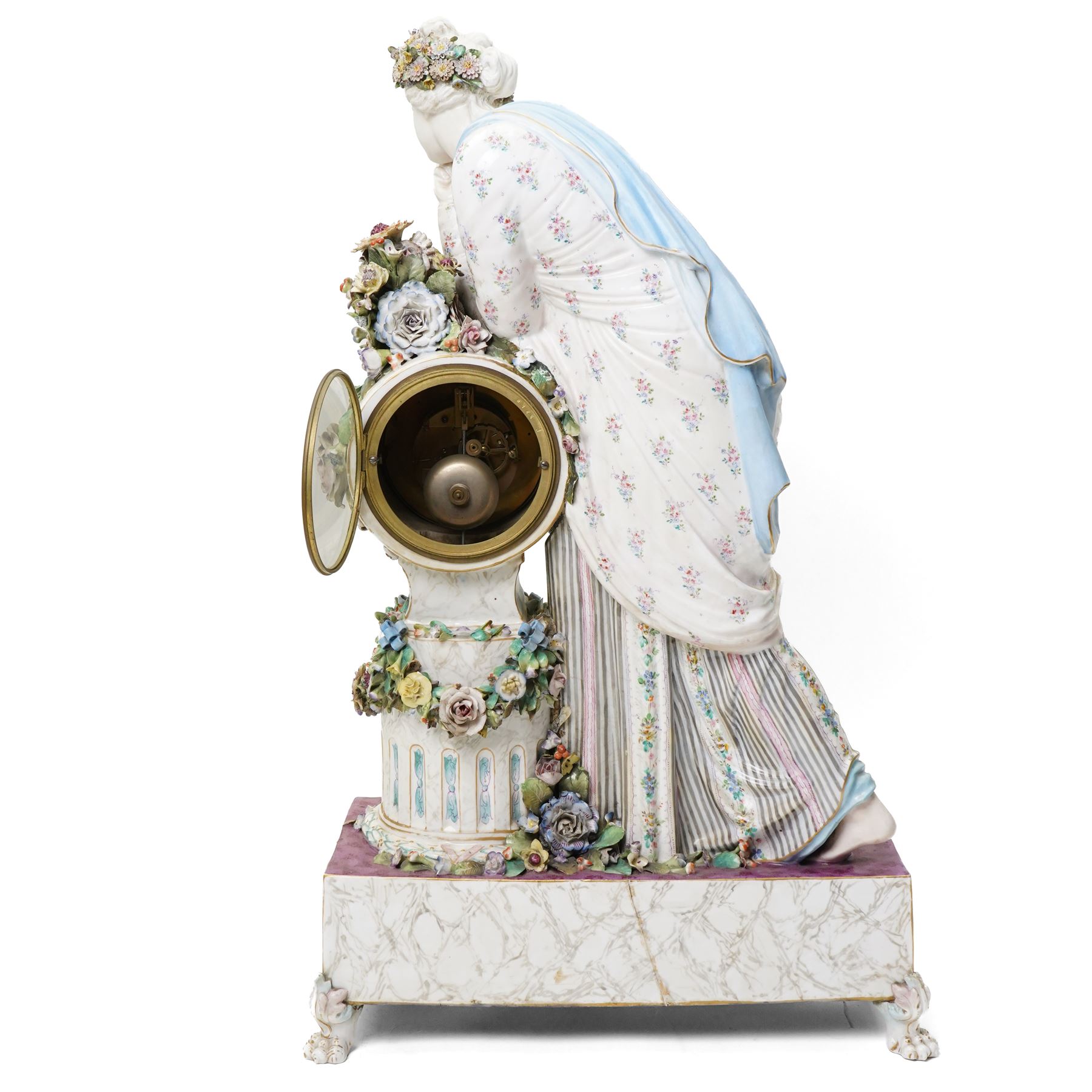 Large19th century  German porcelain mantel clock with white dial and striking movement, the case with a standing figure of Flora resting on a pillar with floral applied decoration, the base painted eith landscape and floral panels on paw feet H77cm W43cm
