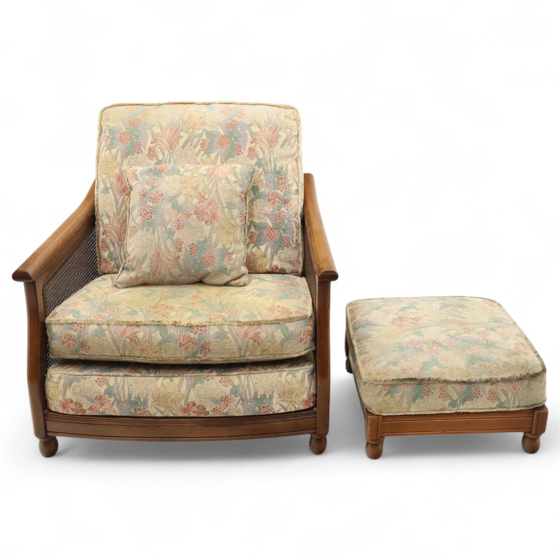 Ercol – bergère four piece suite, including armchair, two seat sofa, three seat sofa and footstool, all with removable floral upholstered cushions, the frames with side caning and rounded arm supports in stained beech

Three seat (H 87cm, D 89cm, W 196cm)
Two seat (H 87cm, D 89cm, W 137cm)
Armchair (H 87cm, D 89cm, W 87cm)
Footstool (H 28cm, D 55cm, W 55cm)