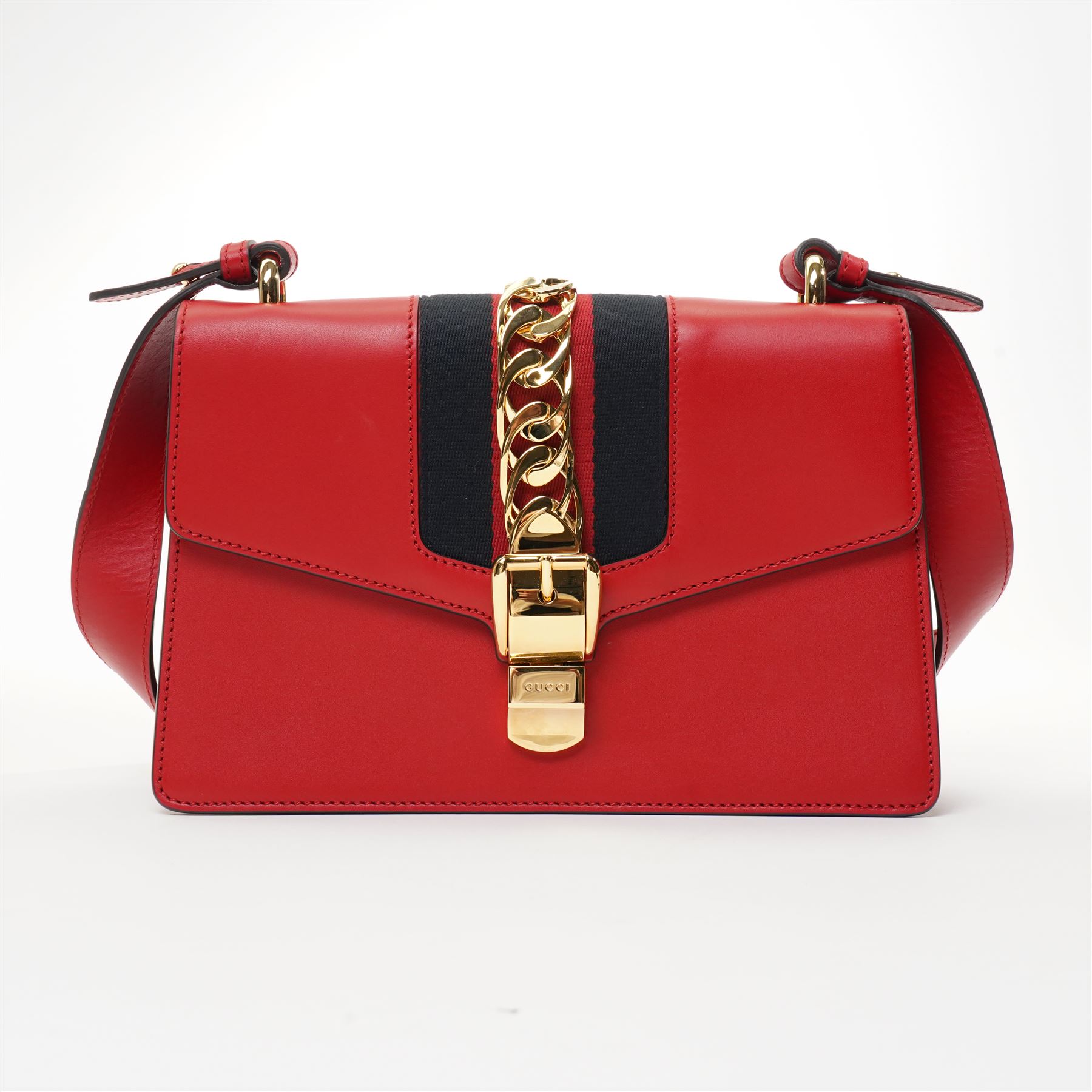 Gucci - ‘Sylvie’ Small Shoulder Bag, introduced circa 2016 under Alessandro Michele, in red calfskin leather with signature web stripe, gold-tone chain and buckle fastening and hardware, flat leather shoulder strap with alternative web-stripe grosgrain strap, unused with original dust bag