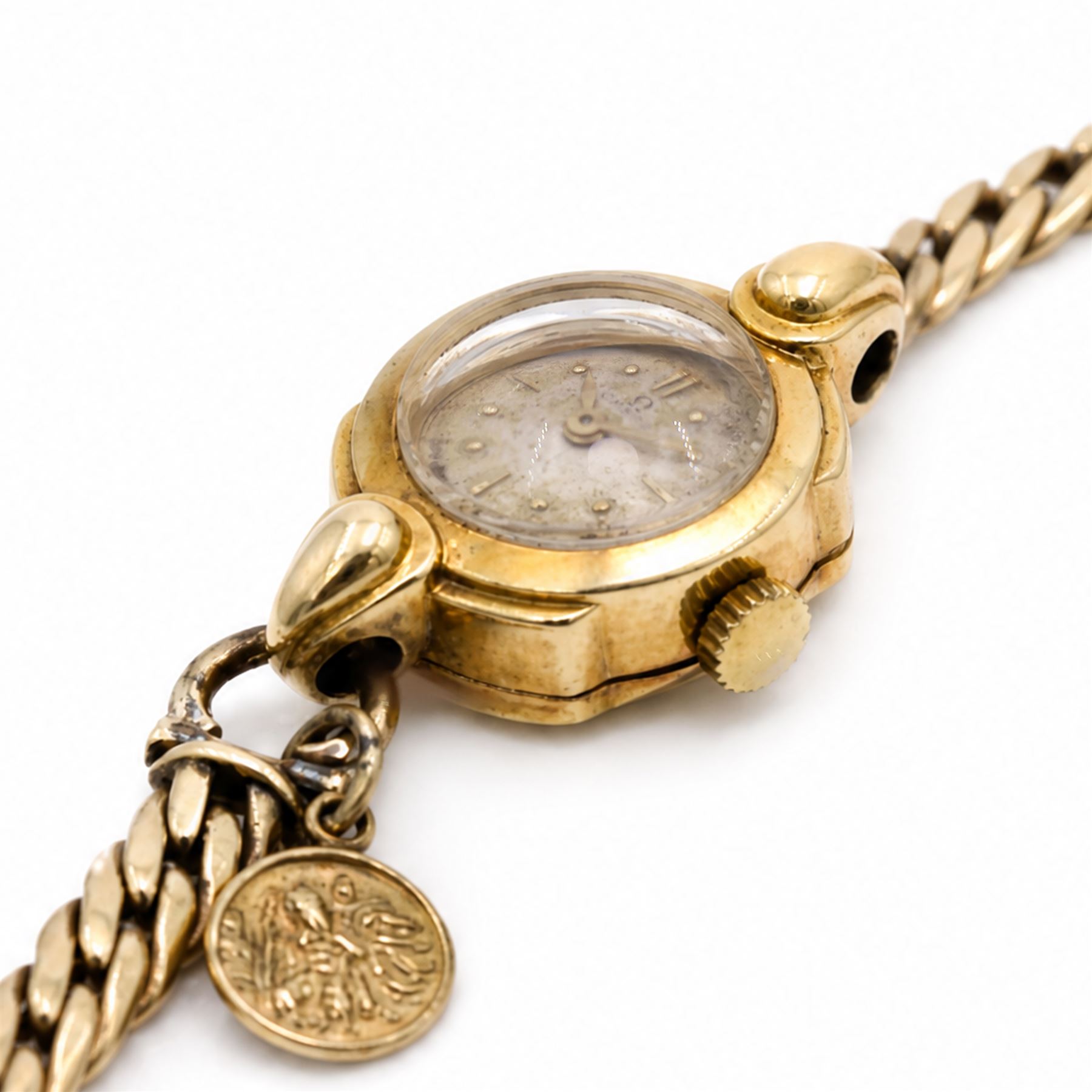 Omega ladies 18ct gold manual wind wristwatch, Cal. 212, silvered dial with dagger and dot hour markers, Birmingham 1953, on 9ct gold bracelet, with fold-over clasp, hallmarked