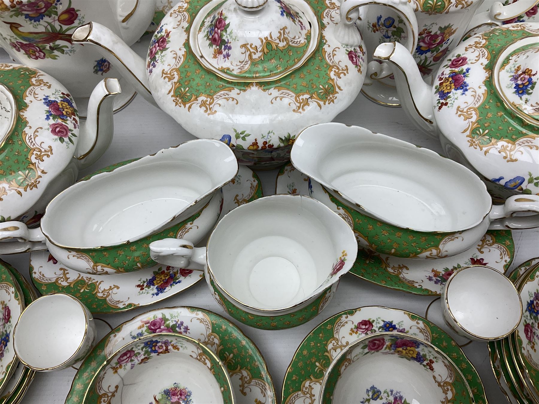 Paragon Rockingham pattern part tea and dinner service including three teapots, milk jug, cups and saucers of various sizes, ten soup bowls, ten side plates, ten dinner plates etc (96)