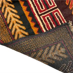 Baluchi dark indigo ground rug, the field decorated with trailing stylised leaf motifs, within a checkered border 