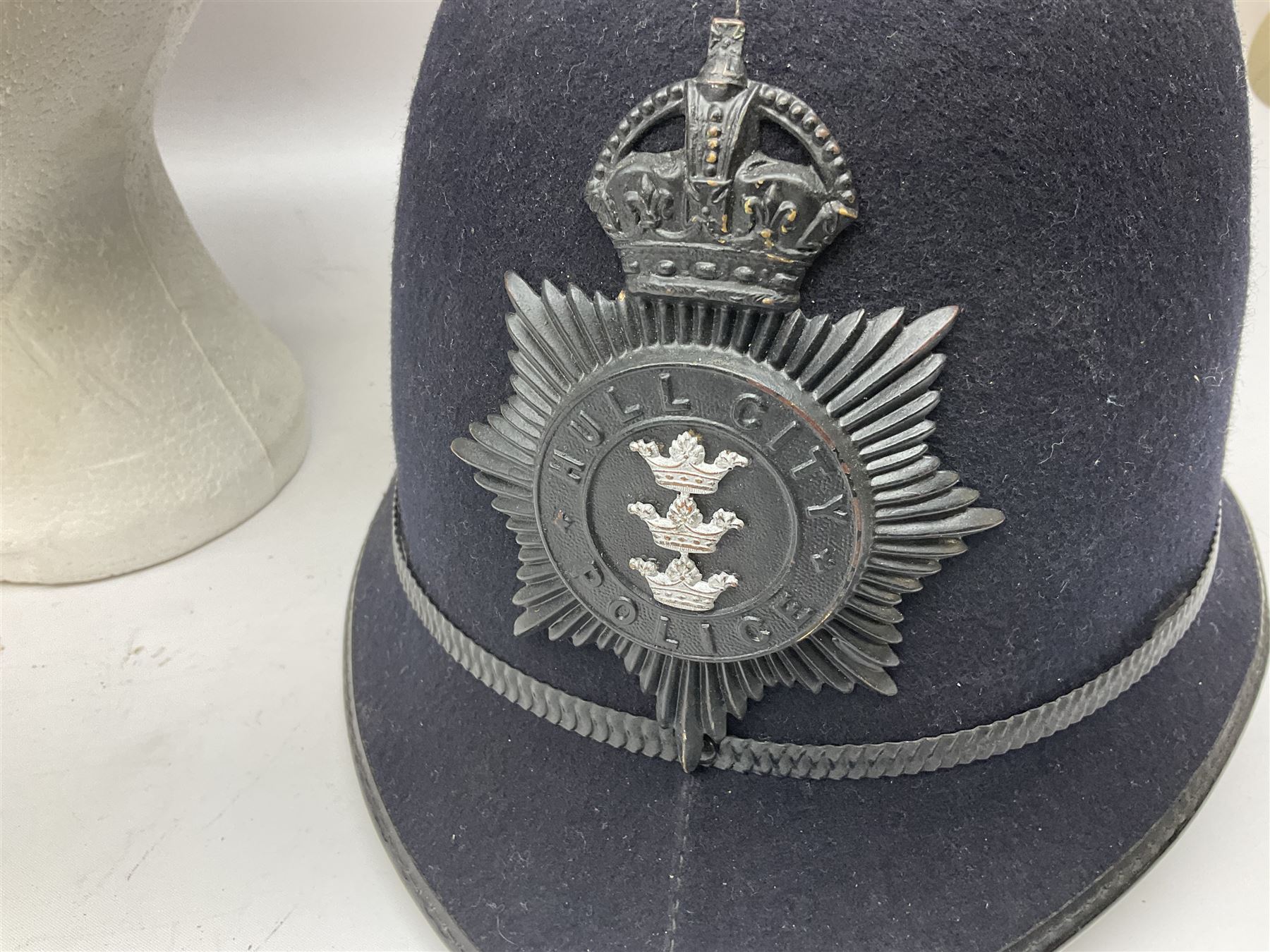 Hull City Police - helmet with king's crown night plate; two further ball-top helmets with Queen's crown plates; and a peaked cap (4)