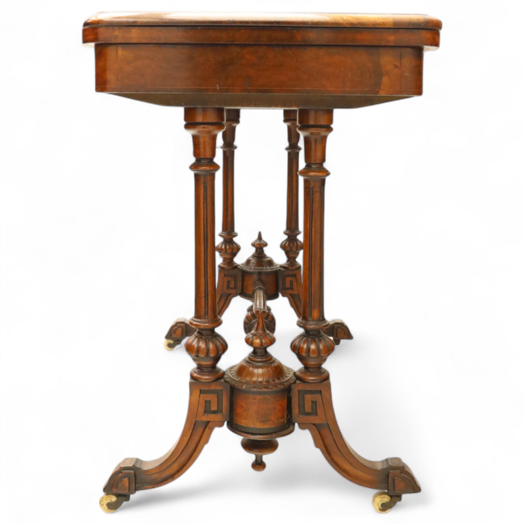 Victorian walnut and inlaid games table, rectangular fold-over top with figured walnut veneers and foliate inlay, swivel and fold over to reveal a green baize lined playing surface, on twin supports united by a stretcher, raised on scroll carved feet with castors (extended 96cm x 92cm)