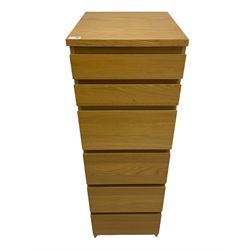 IKEA light oak finish chest, fitted with hinged vanity top, above six graduating drawers