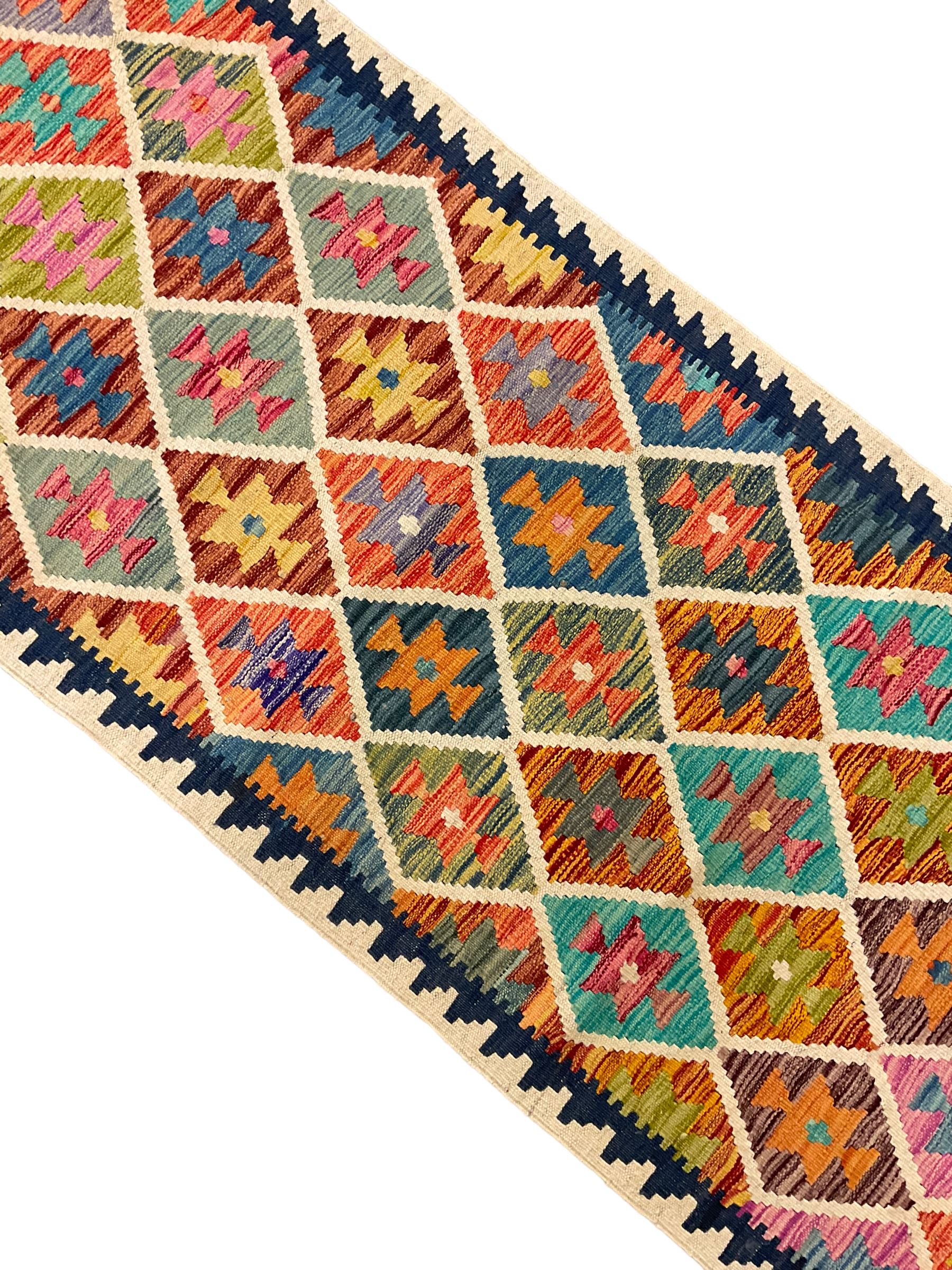 Anatolian Turkish Kilim ivory ground runner rug, decorated with all over multi-colour geometric lozenges with ivory outline