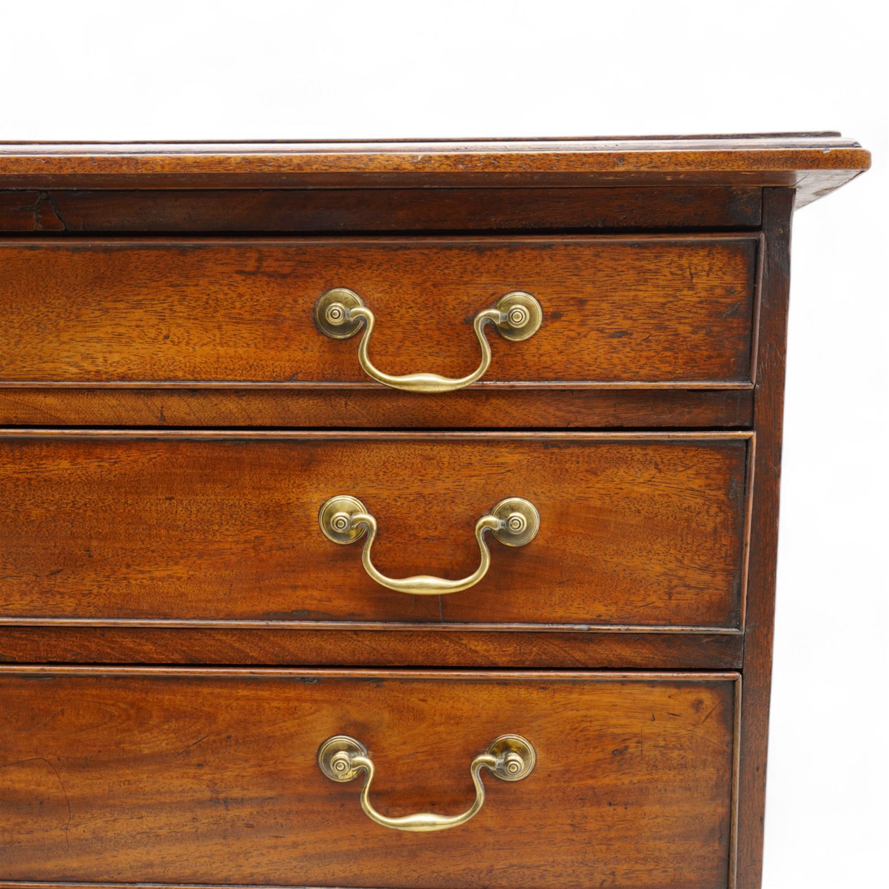 George III mahogany chest, moulded rectangular top over five long cock-beaded drawers, each fitted with brass swan neck handles and circular plates, with shaped brass escutcheons, lower moulding over ogee bracket feet 