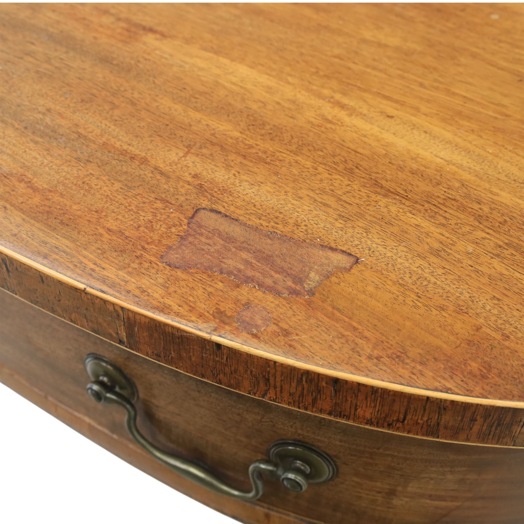Early 20th century mahogany bow front sideboard, the shaped and moulded top above central kneehole recess with baize lined frieze drawer, flanked by twos drawers either side with the lower drawer double height, raised upon square tapering legs with spade feet