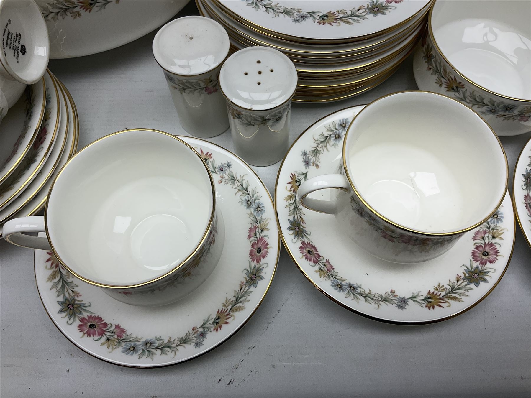 Royal Albert Paragon tea and dinner service for twelve decorated in the Belinda pattern, comprising fourteen saucers, twelve teacups, thirteen side plates, teapot, sauce boat and stand, salt and pepper shakers, two jugs, sucrier, twelve dinner plates, twelve smaller plates, two lidded tureens, twelve bowls, twelve smaller bowls, cake plate, oval plate and oval dish (100)