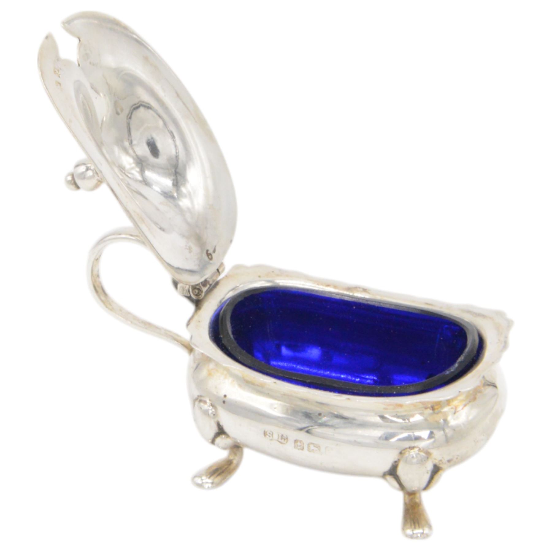 1920s silver five piece cruet set, comprising two pepper shakers, two open salts and a mustard pot, all of oval form and upon four pad feet, hallmarked William Suckling Ltd, Birmingham 1923