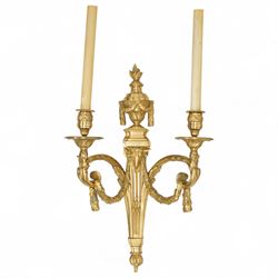 Pair of 19th-century Louis XVI-style ormolu rams-headed two-light wall appliques, the arms joined by a garland of laurel leaves, the half fluted stem surmounted by a vase with laurel garland, wired for electricity 
