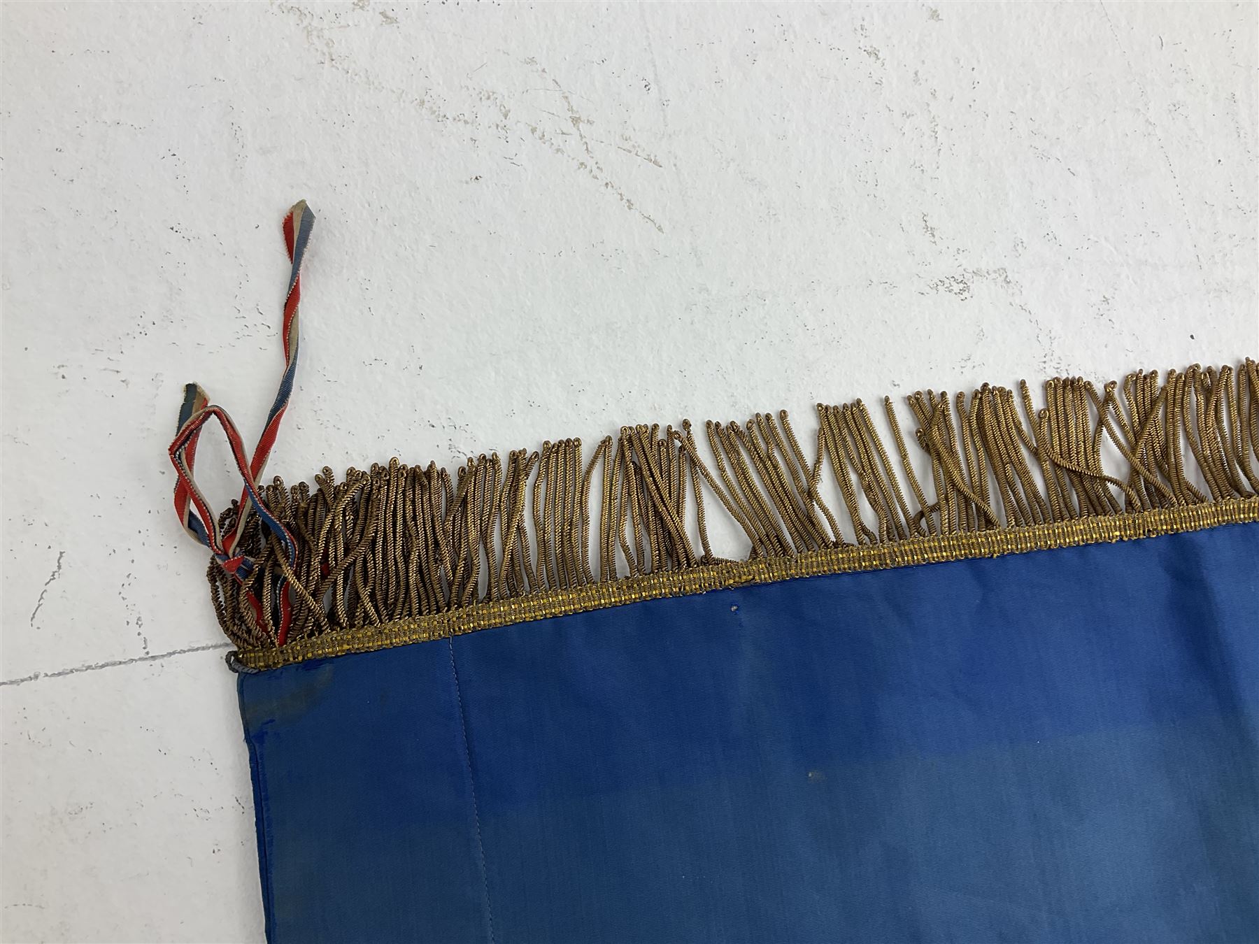 French State Police banner as the tricolor flag embroidered with coloured and metallic thread 'Societe De Secours Mutuels Un Pour Tous Tous Pour Un De La Police D'Eteat De Marseille' to one side; plain flag verso; tassels to three sides 100 x 113cm