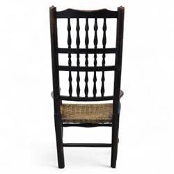19th century country elm spindle back armchair, shaped cresting rail over two rows of turned spindles, shaped open arms over rush seat, on front turned supports, joined by stretchers 