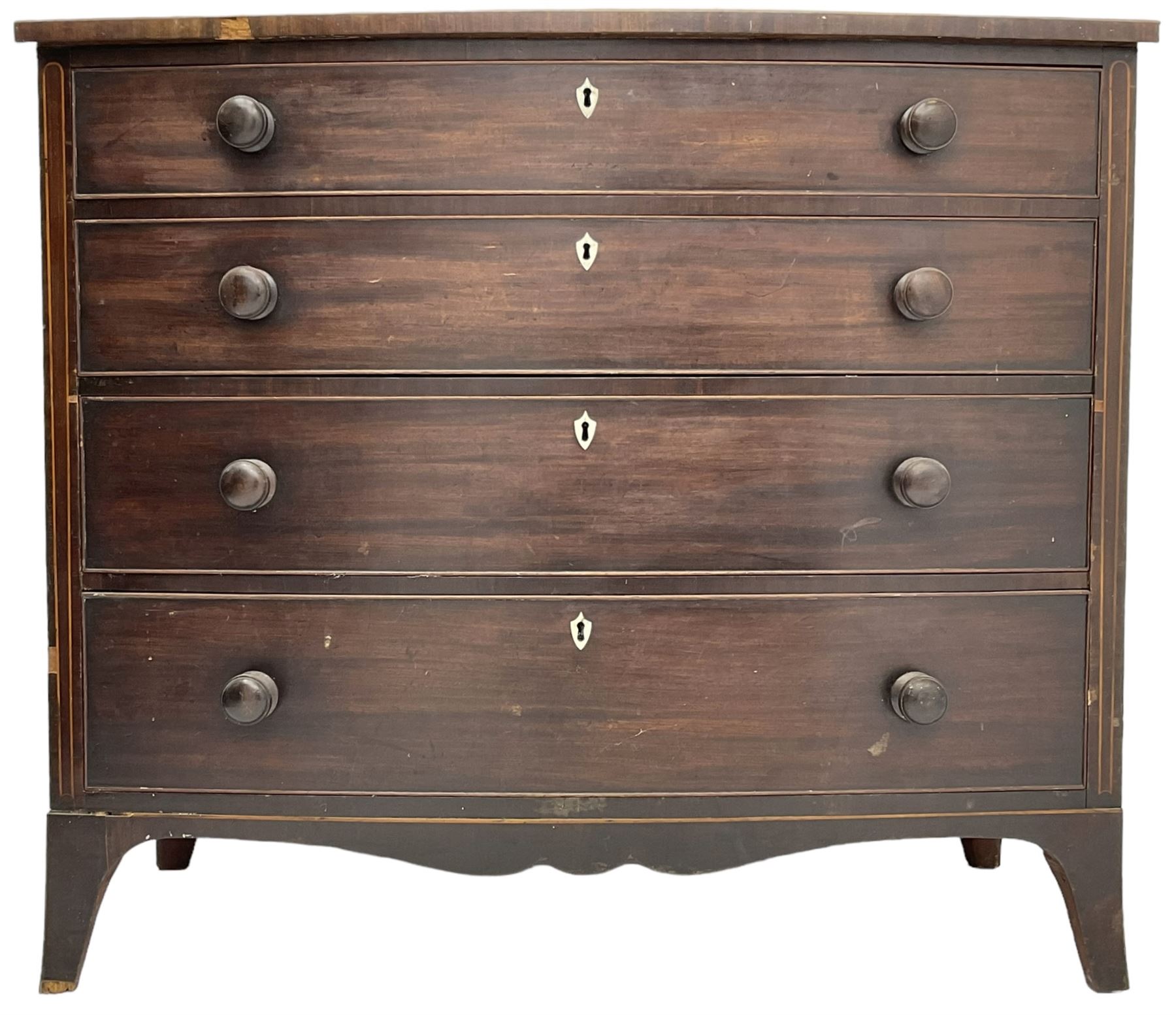George III mahogany bow-front chest, crossbanded top with satinwood stringing, fitted with four graduating cock-beaded drawers, each with bone shield shaped escutcheons and turned handles, shaped apron flanked by splayed feet