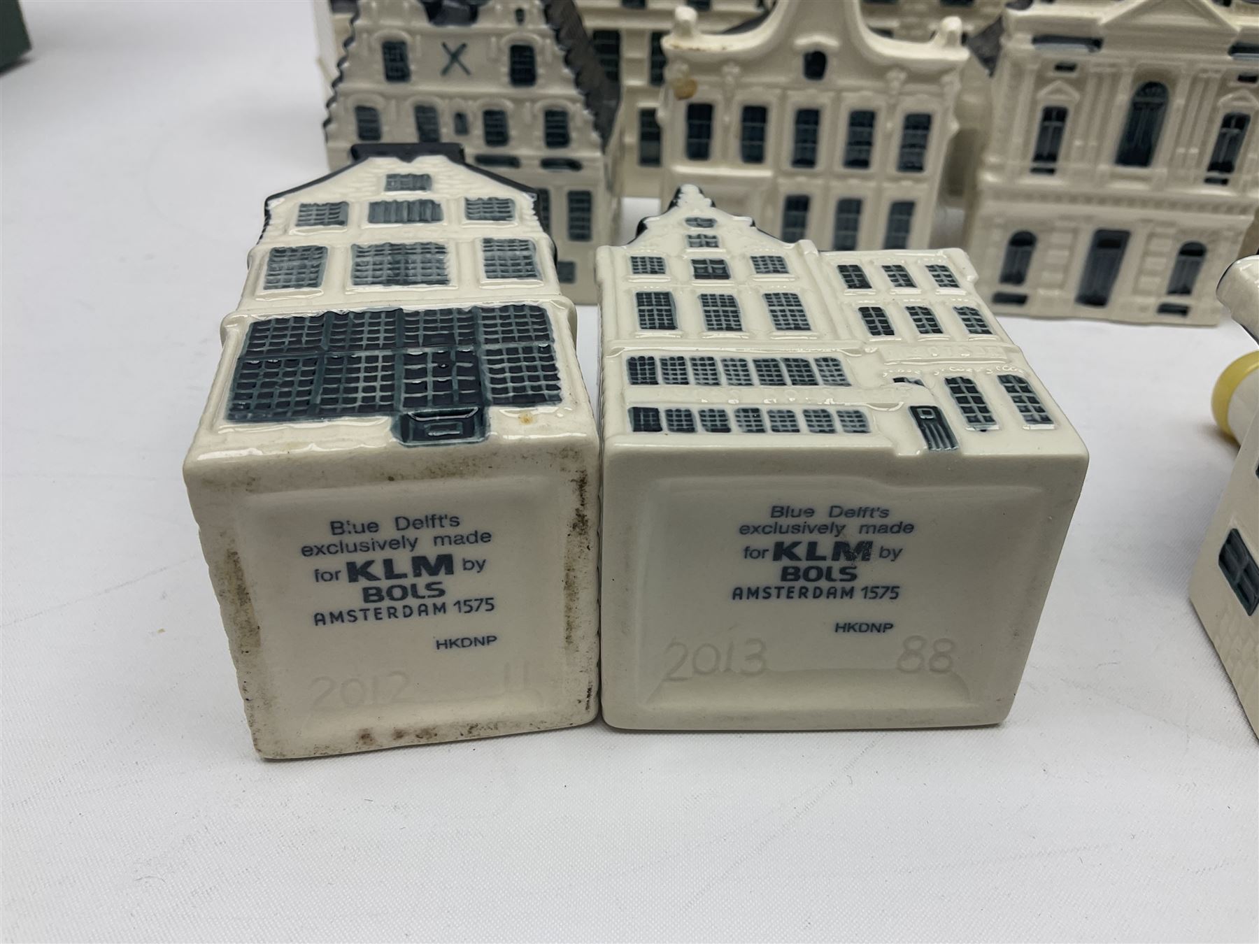 Twenty seven KLM Bols Blue Delft's decanters in the form of Dutch houses, some with contents