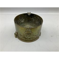 Trench Art - three WW2 brass shell case ashtrays, one mounted with Royal Artillery cap badge and button and one mounted with RA button; together with a pair of place name holders each formed from a Royal Artillery cap badge (5)