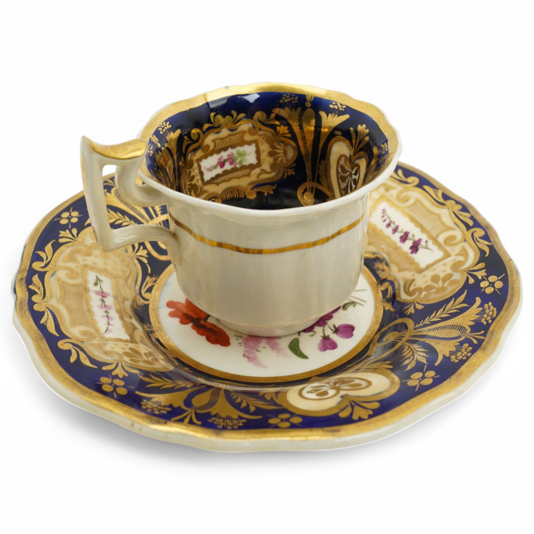 19th century teacup and saucer, possibly Coalport, decorated with panels of flowers on a cobalt blue ground with gilt decoration; together with two other teacup and saucer pairs, one with hand painted landscape decoration 