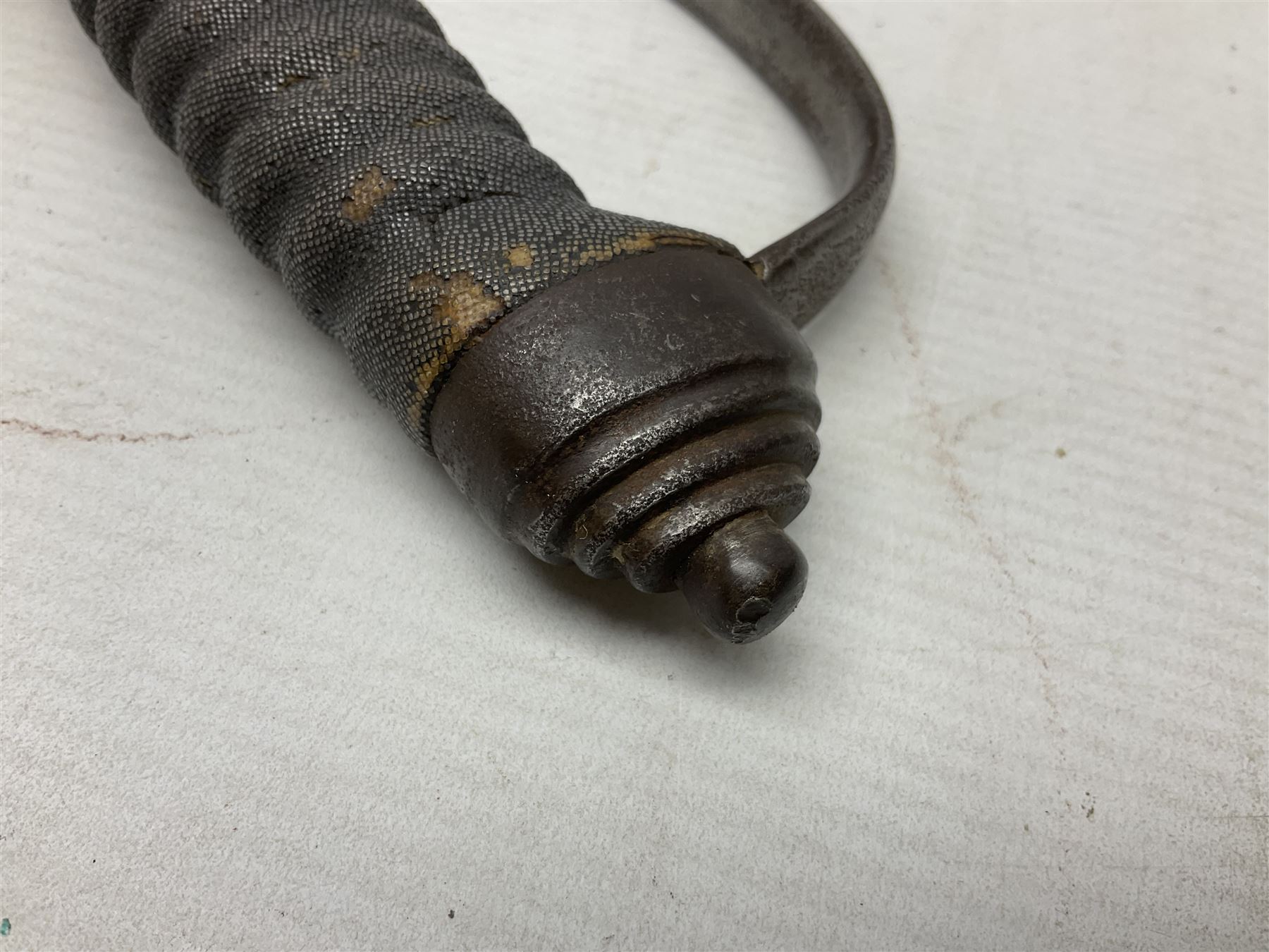 Mid-19th century Custom’s officer/Constabulary sidearm, with plain 60.5cm slightly curving fullered blade double edged at tip,  steel knucklebow and downswept quillon, stepped pommel and ribbed fishskin grip; in leather covered scabbard with steel locket, frog stud and chape L76cm overall