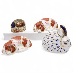 Four Royal Crown Derby paperweights, comprising Blue Ladybird, Two Puppy and Rabbit all wi...