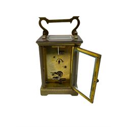 An early 20th century French timepiece carriage clock in a Corniche case with a white enamel dial , Roman numerals, decorative steel hands and minute markers, four bevelled glass panels and a rectangular panel to the top, with a replacement jewelled lever platform escapement with timing screws.