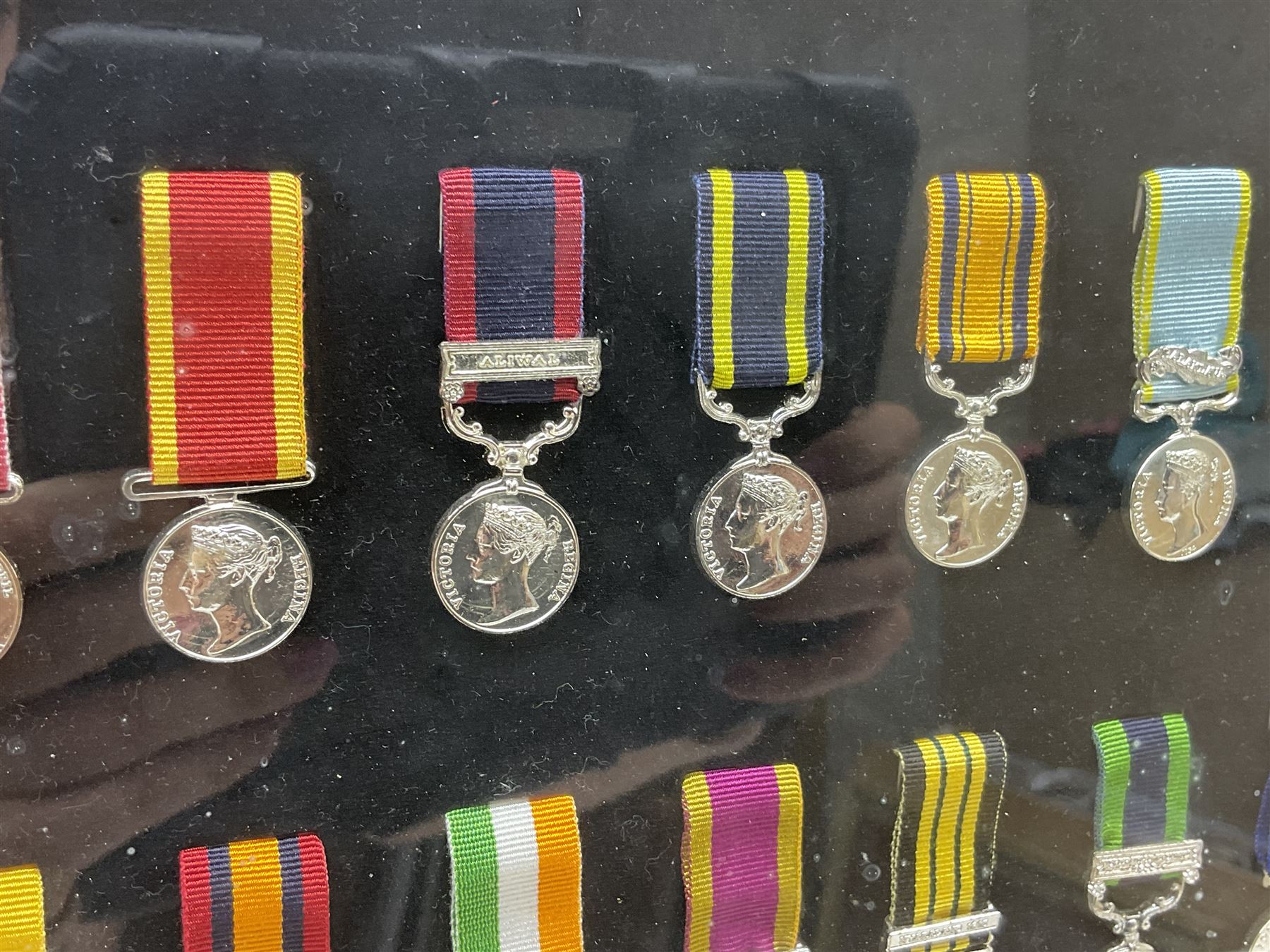 Limited edition large framed display board with sixty half-size copies of British Gallantry and Campaign Medals produced by Danbury Mint; all with ribbons and associated booklet