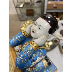 Pair of 20th century Chinese figural bookends, modelled as children in traditional blue dress sat reading and kneeling upon stacks of books, H22cm
