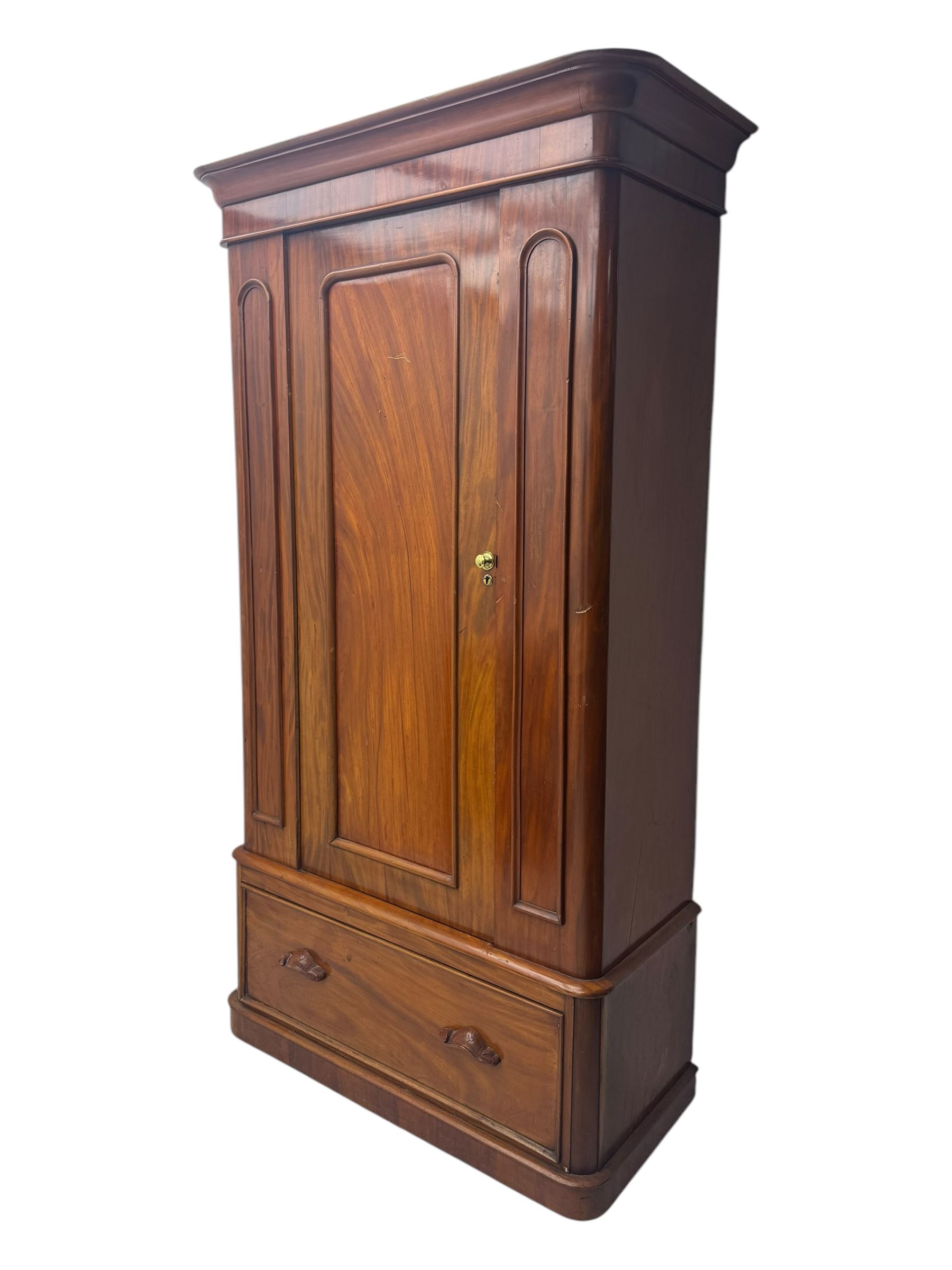 Large Victorian mahogany wardrobe, projecting moulded cornice over single panelled door enclosing hanging hooks and sliding rail, the base fitted with full width drawer, on plinth base

