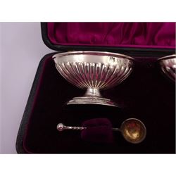 Two Victorian silver open salts, of part fluted navette form with gilded interior, upon stepped oval bases, with a pair of silver salt spoons, with twisted handles and gilded bowls, spoons and one salt hallmarked Nathan & Hayes, Birmingham 1895, other salt hallmarked George Nathan & Ridley Hayes, Birmingham 1894, contained within tooled leather velvet and silk lined fitted case, salts H4cm