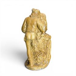 Composite garden statue group of Romeo and Juliet embracing in Medieval dress, surmounted on a naturalistic foliate base, in antique distressed glazed finish