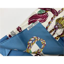 Hermès 'Le Timbalier' silk scarf, designed by Francoise Heron in 1961, printed with a central image of a gentleman on horseback donning extravagant dress, on white ground surrounded with colourful stylised knotted ropes, contained within peacock blue border, with rolled hand stitched edges and Hermes material label, 87cm square