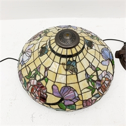 A Tiffany style standard lamp, the bronze effect art nouveau inspired based (lacking one column section), supporting a large glass shade decorated with flowers and butterflies. 