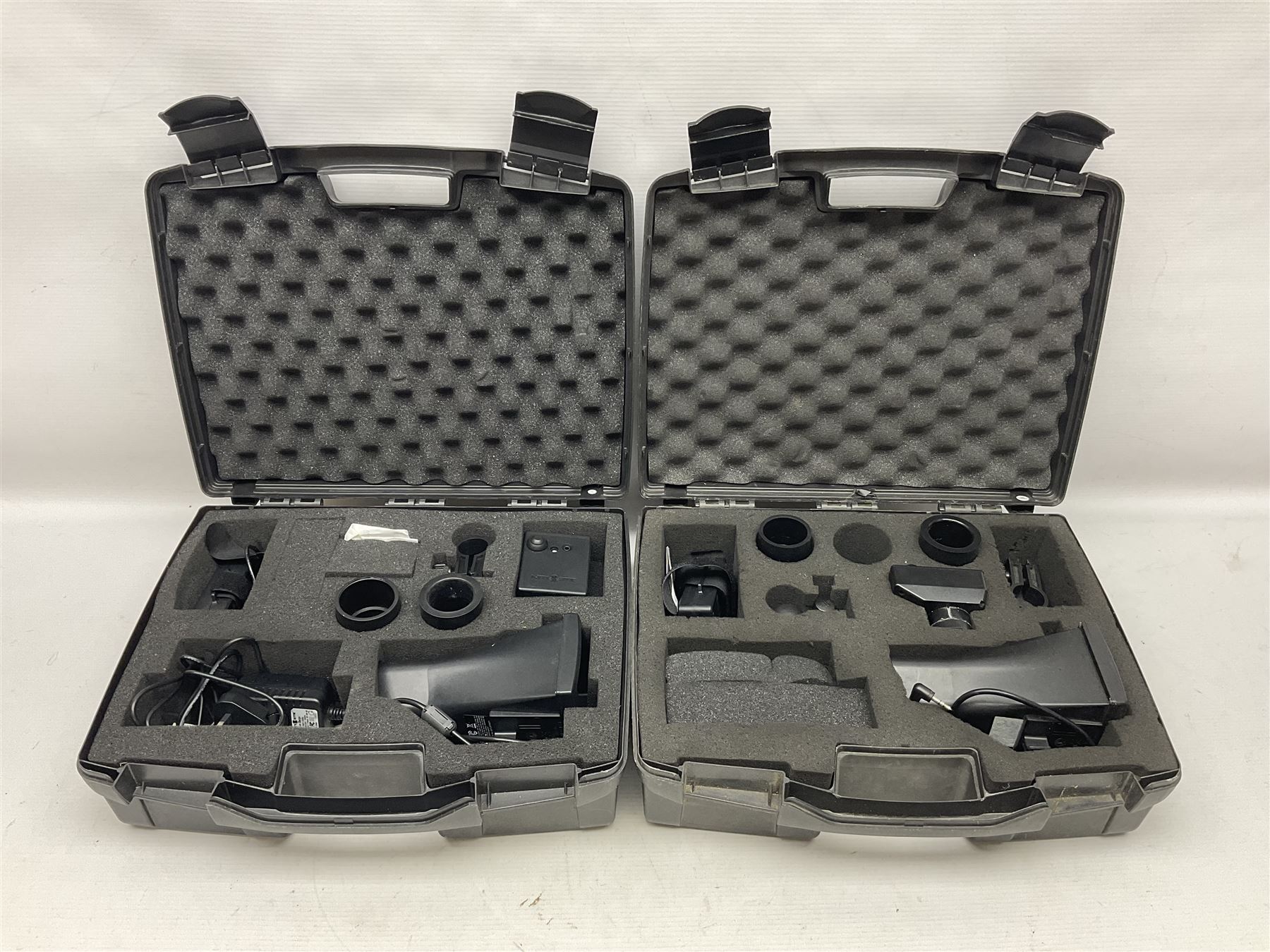 Two Nite-Site add-on kits in hard plastic carrying cases; one with charger