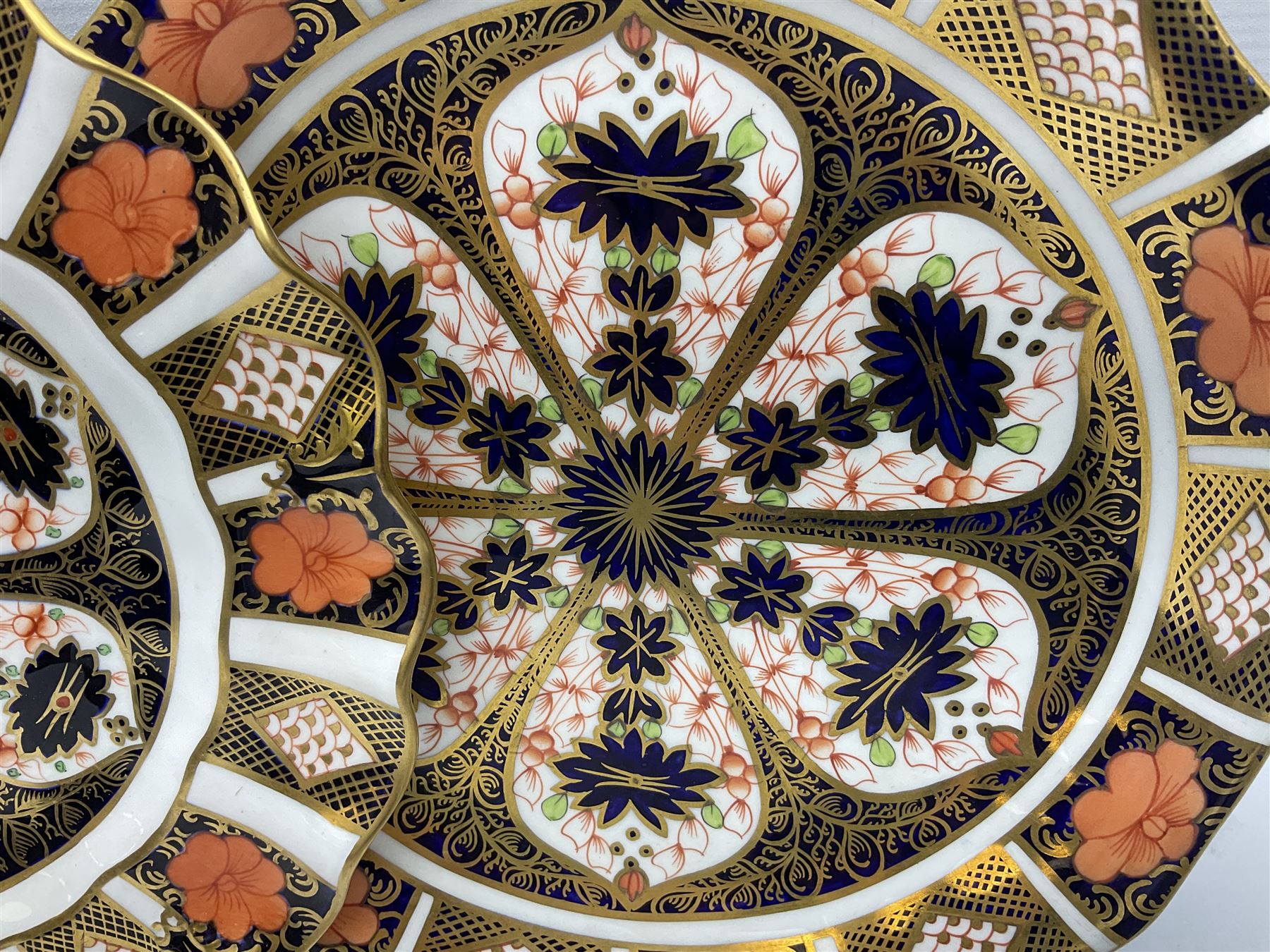 20th century Royal Crown Derby Imari 1128 pattern tea wares, comprising six teacups, five saucers, five side plates, a pair of serving plates, and one other with wavy rim, each with printed marks beneath including various year cyphers, side plates D16cm serving plates each approximately D22cm