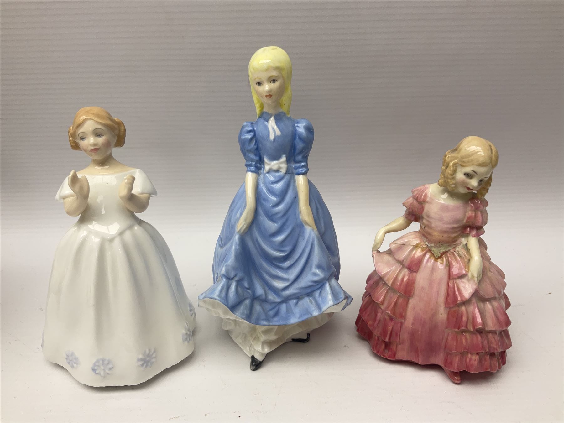 Five Royal Doulton figures, including Shore Leave HN2254, The Old Balloon Seller HN1315, Rose HN1348 etc, together with Royal Worcester Coquette