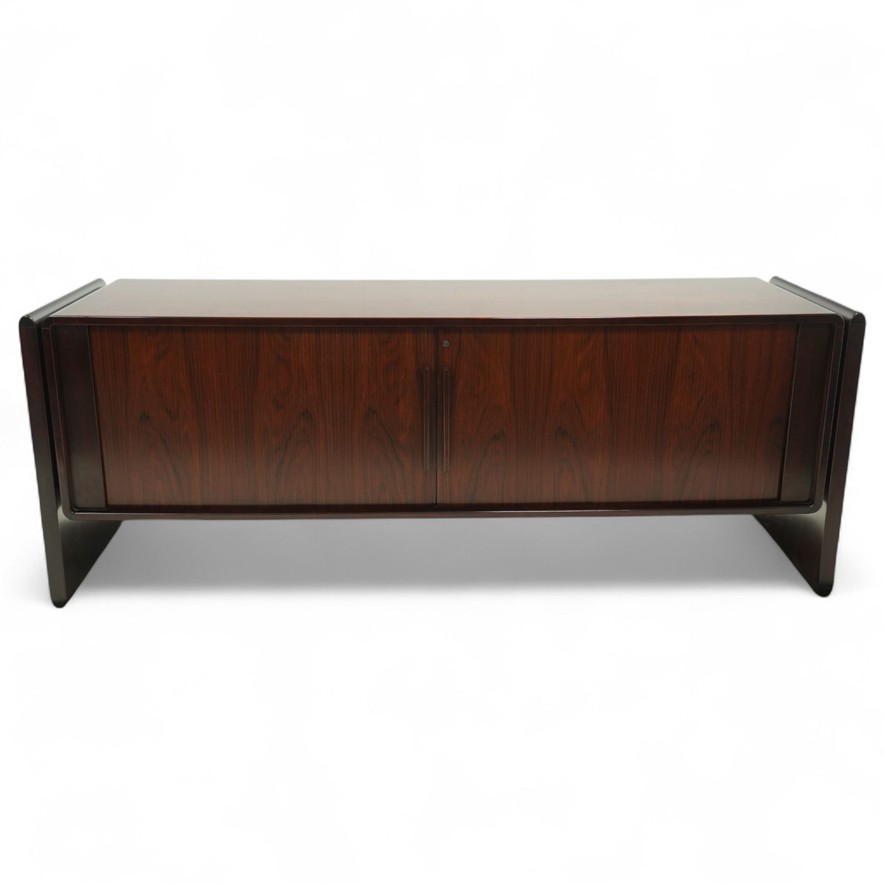 Dyrlund  - contemporary Santos rosewood office sideboard of minimalist form with clean lines, rectangular top with integrated side supports, left side with two drawers, and right side with a filing drawer, all enclosed by sliding doors


Note: Dyrlund is a Danish furniture manufacturer known for its high-quality, handcrafted pieces, particularly in the mid-century modern style. Founded in 1960 by Frits Hjerte Dyrlund in Rude, Denmark, the company has remained a family business, now run by the second and third generations. Dyrlund specializes in both home and executive office furniture, focusing on practicality, solid construction, and classic design. 
