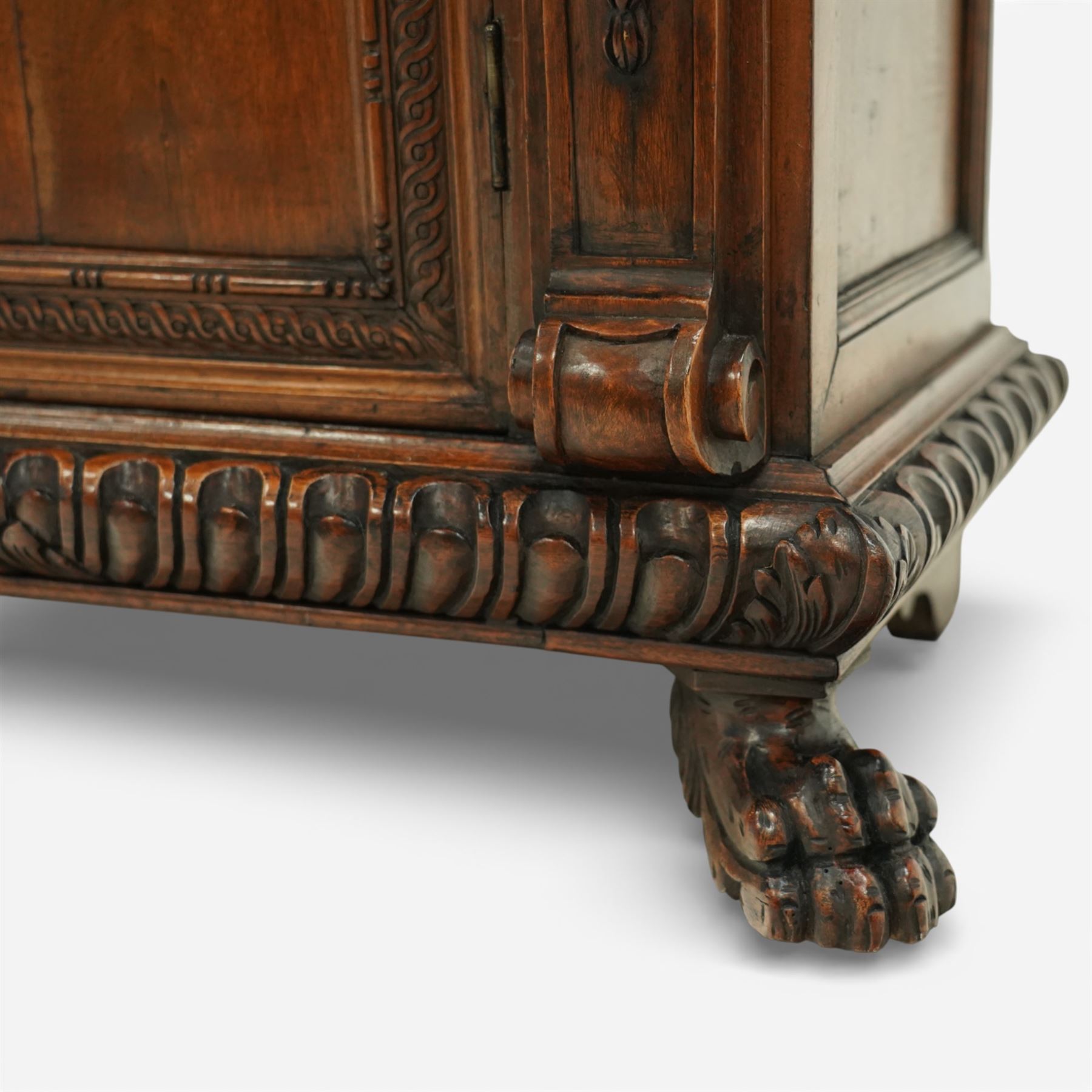 19th century Italian walnut Renaissance Revival side cabinet, the moulded rectangular top above a frieze drawer carved with vertical fluting and a central rosette, with egg-and-dart moulded rails to the top and base, acanthus-carved corbels below, the panelled cupboard door framed by beading and guilloche ornament, flanked by carved caryatids modelled as classical female architectural supports with foliate terminals, raised on paw feet