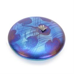 John Ditchfield for Glasform disc paperweight in iridescent blue with purple lily trail and silver hallmarked butterfly to top, D12cm