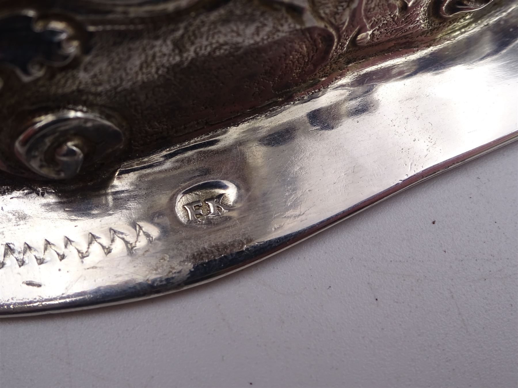 German silver chalice, the bowl, stem and foot each with 19th century repousse and chased decoration depicting putti masks, C scrolls and flowers, set with two hand painted porcelain roundels, possibly Berlin, and six later applied enamel roundels, each depicting religious scenes, the gilded bowl upon knopped stem and spreading octofoil foot, the base with marks for Munich, c.1695 and maker's mark FK