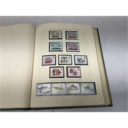 Queen Elizabeth II mint decimal stamps, face value of usable postage approximately 2250 GBP, housed in three albums